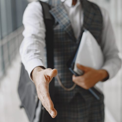 Close up portrait of grinning old-fashioned man. Elegant man at the office. Senior with a documents.